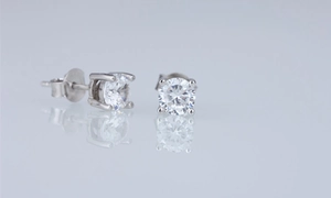 Close-up of silver round zircon stud earrings with classic four-prong setting