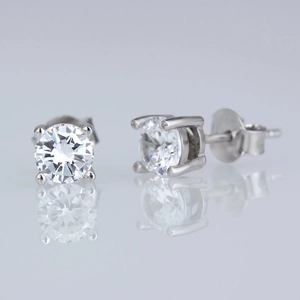 Macro shot of silver stud earrings with classic four-prong set round cubic zirconia