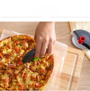 Close-up of ergonomic circular pizza cutter with stainless steel blade and protective cover