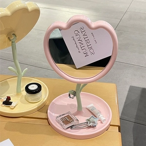 Pink tulip-shaped plastic makeup mirror with base tray for tabletop vanity decor