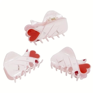 Pink heart-patterned hair claws set with rhinestone accents in various angles