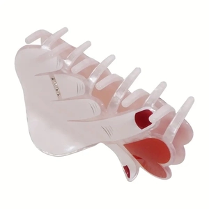 Pink palm hand hair claw clip with red nails and rhinestone accents for heart-shaped hair styling
