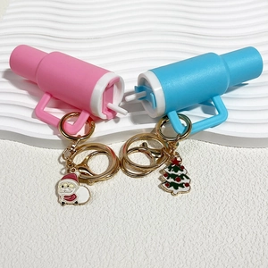 Stanley style cup keychain with Santa and Christmas tree charms in pink and blue