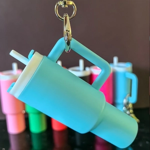 Detailed close-up of a turquoise mini tumbler keychain with handle and straw accessory