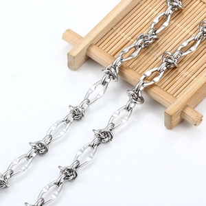 Polished silver stainless steel barbed wire style link chain on a bamboo stand