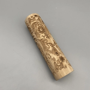 Detailed laser-engraved floral patterns on a wooden Christmas rolling pin for baking
