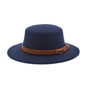 Macro shot of navy wool fedora showing brown leather band and gold buckle detail