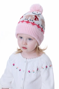 Detail of pink knitted baby hat with reindeer patterns and matching flower cardigan