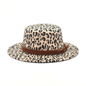 Detail of leopard print flat top wool hat with brown suede belt and golden buckle