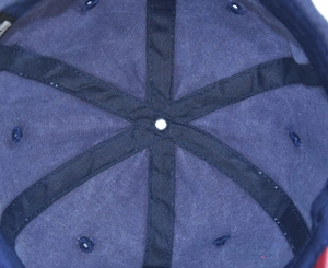 Detail of the navy blue cotton baseball cap interior showing six-panel stitching and seams