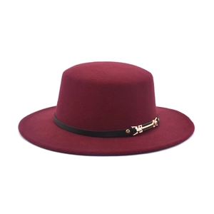 Detail of wool fedora with flat brim featuring a black leather band and gold metal buckle