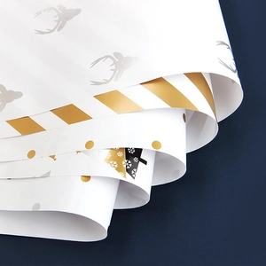 Christmas wrapping paper set with gold reindeer and snowflake patterns on white background