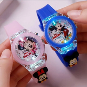 Close-up of pink and blue glowing LED cartoon watches with Minnie and Mickey designs
