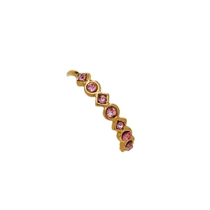 Adjustable gold plated stainless steel ring with six round pink crystals on white background