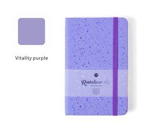 Detail view of the purple glitter notebook with elastic strap and artistic rainbow cover