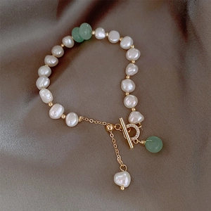 Baroque freshwater pearl bracelet with green beads, gold OT buckle and heart charm