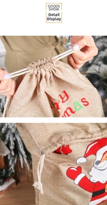 Detail of Christmas burlap drawstring bag showing festive Santa print and sturdy rope closure