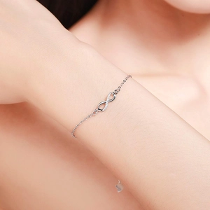 Close-up of 925 sterling silver infinity symbol bracelet with white cubic zirconia stones