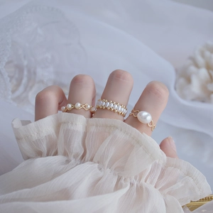 Detailed shot of 14k gold plated pearl rings with vintage freshwater pearl accents