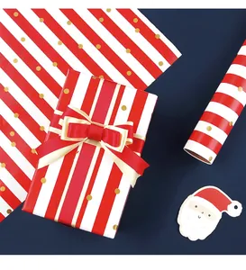 Detailed view of red and white striped Christmas gift wrapping paper with gold foil dots