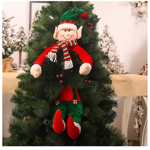Close-up of Christmas elf plush toy with green hat and striped scarf on a festive tree