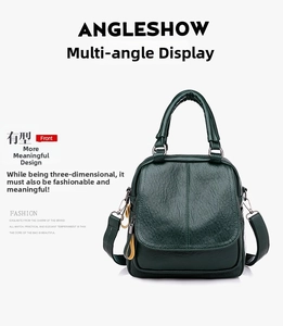 Detailed view of dark green pebbled leather texture on a multi-way handle bag