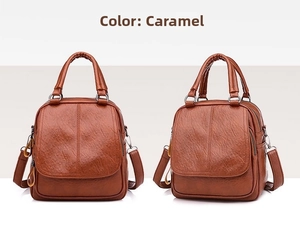 Detail of caramel faux leather bag featuring retro zippers and adjustable straps