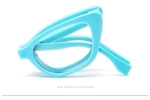 Detail view of foldable cat-eye sunglasses with bright blue frame and stylish structure