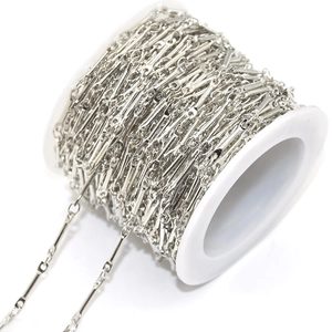 Detailed view of bright silver DIY jewelry chain wrapped on a white spool for crafting
