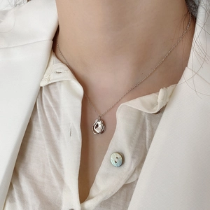 Elegant 925 sterling silver geometric pendant necklace on model with white blazer