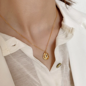 Minimalist 925 sterling silver irregular lava pendant necklace in gold on a model