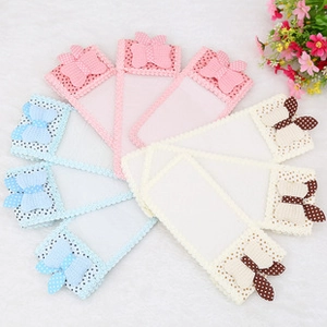 Macro detail of baby sweat-absorbing towels with decorative 3D bow knots in pastel colors