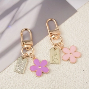 Handmade floral keychains with colorful enamel flower pendants on gold-plated metal clips