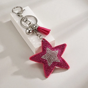 Detail of pink star keychain featuring sequins, silver tassel and sparkling rhinestones