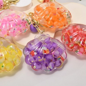 Luminous shell-shaped liquid glitter keychain with colorful beads and fruit slices