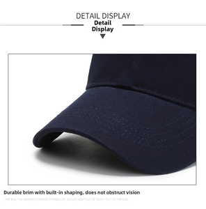 Detail of navy blue cotton baseball cap peak with sturdy stitching and fixed shape