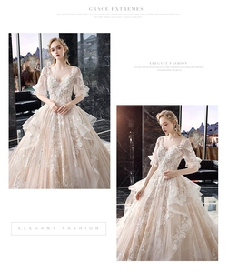 Detailed close-up of V-neck bridal gown with lace embroidery and layered ruffle sleeves