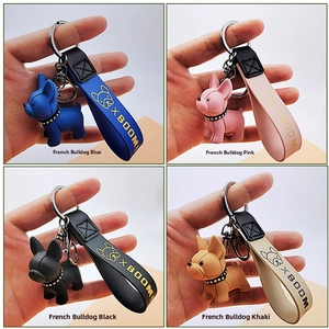 Detail of colorful cartoon French Bulldog keychains with leather straps in four colors