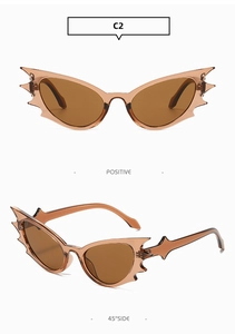 Detailed view of brown translucent bat-wing sunglasses with a Y2K gothic cat eye frame
