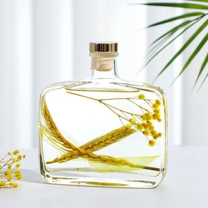 Preserved yellow flower reed diffuser in a glass bottle with golden cap for home decor