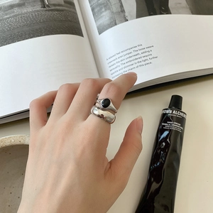 Detail of 925 sterling silver rings with black agate stone worn on a finger