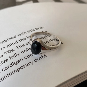 Macro detail of S925 sterling silver ring with black onyx stone on a vintage book