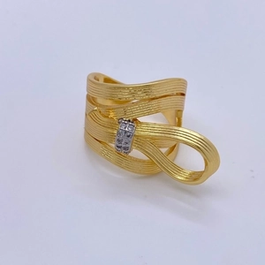 Brushed 18K gold bow ring with layered ribbon design and sparkling diamond accents