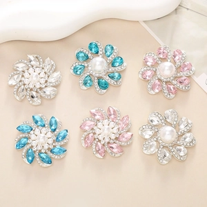 Detailed view of floral shoe charms with large pearls and sparkling rhinestones