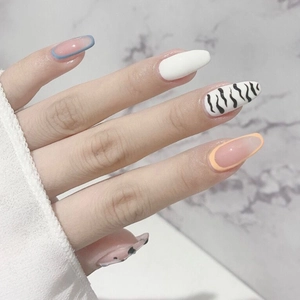 Chic ballet style press-on nails with cream zebra patterns and colorful edge designs