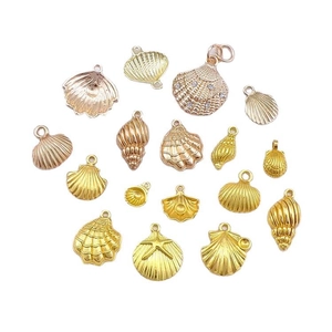 Assorted gold shell and starfish alloy charms for DIY jewelry making on white background