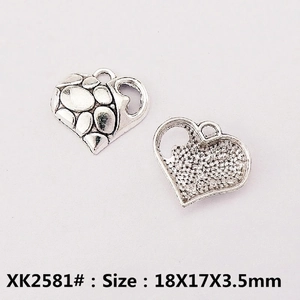 Macro detail of heart charm pendant showing pebble texture and 18x17mm dimensions