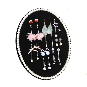 Collection of assorted stylish earrings displayed on a black velvet jewelry display stand
