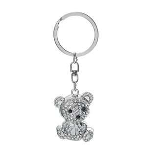 Close-up of sparkling crystal-encrusted bear keychain with a bow tie and metal clip