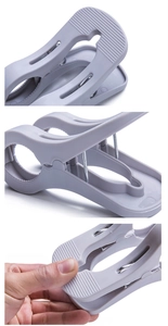 Macro detail of large plastic windproof quilt clip showing spring and anti-slip grip